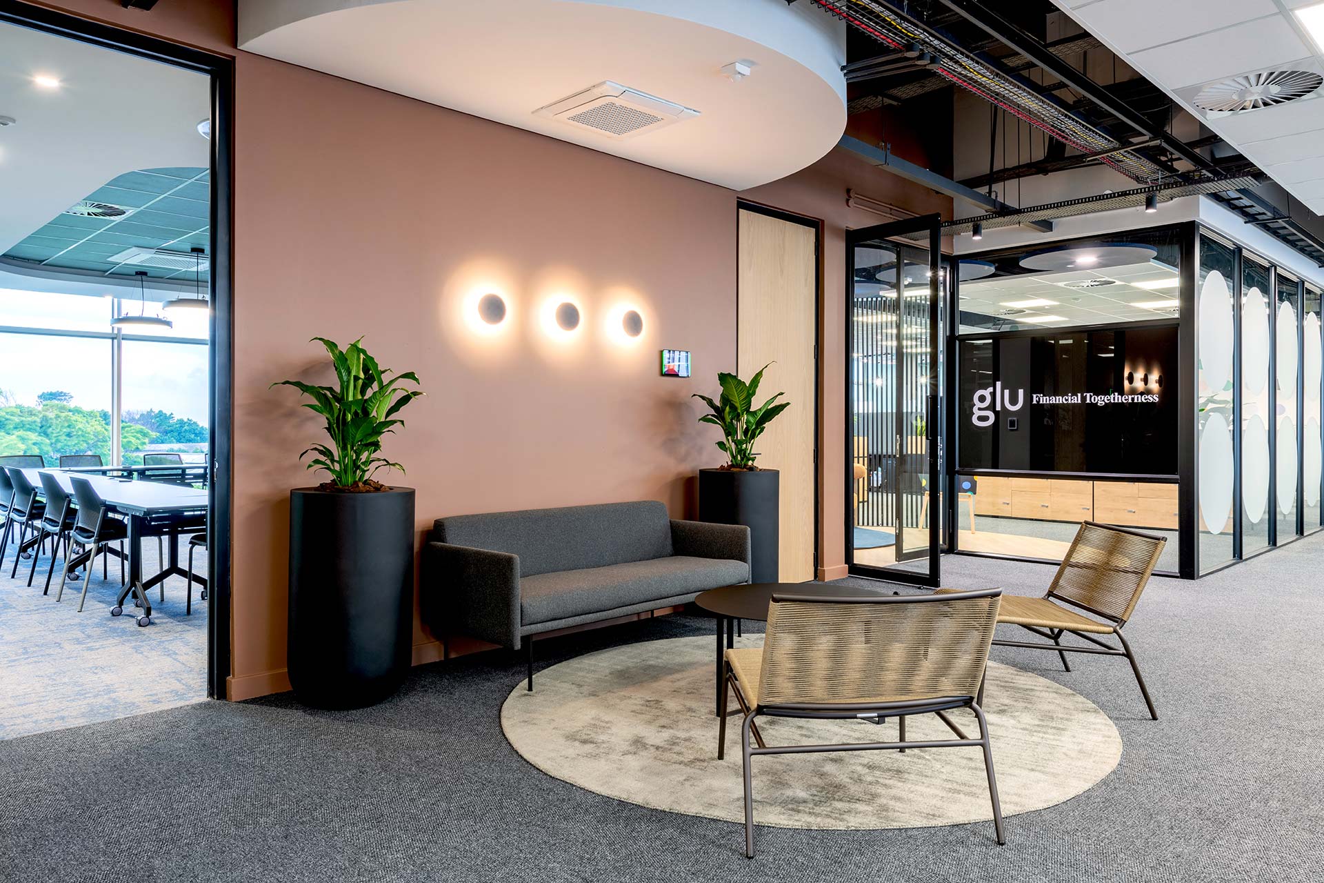 PPS Glu large financial office interior design and build with modern reception couches and planters