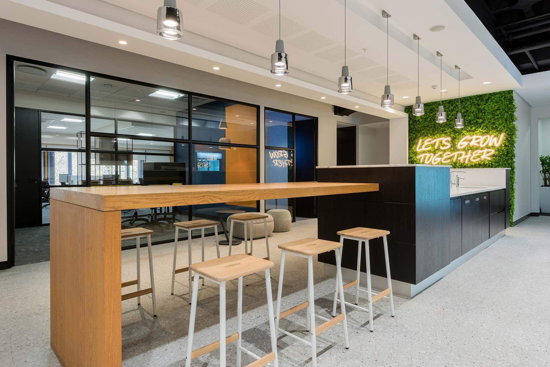 Open plan flexible office space with green wall and led lighting
