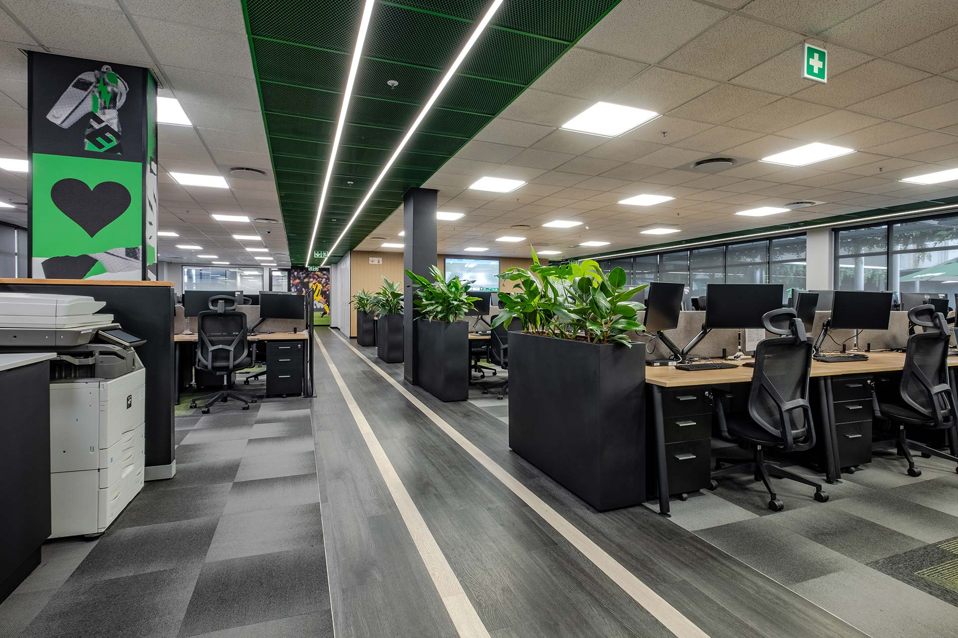 sports references are visible in the open plan office area for this workspace design