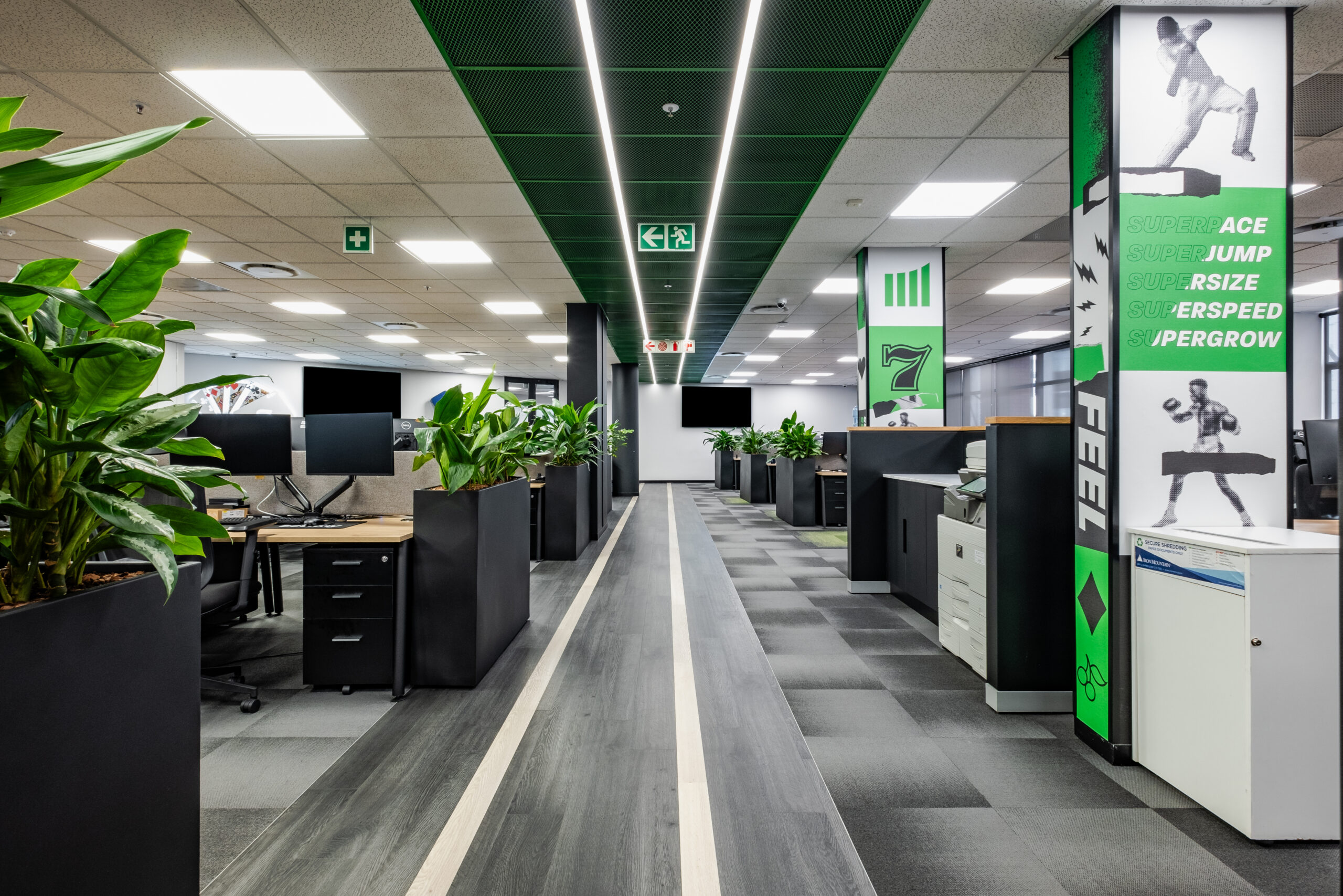 Brand colours and immersive features can be seen in the open plan interior office space
