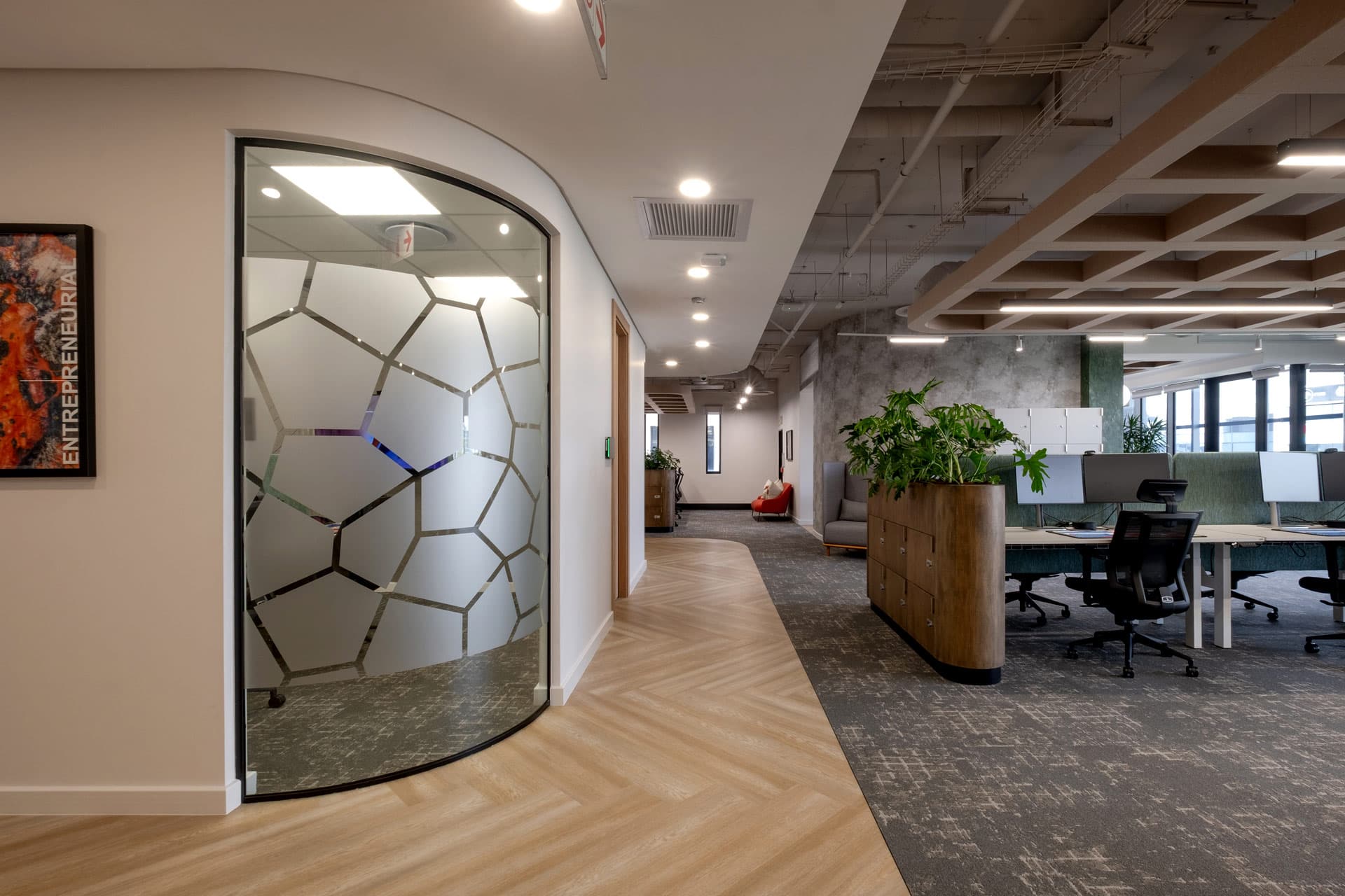 Modern office layout with frosted glass and desks