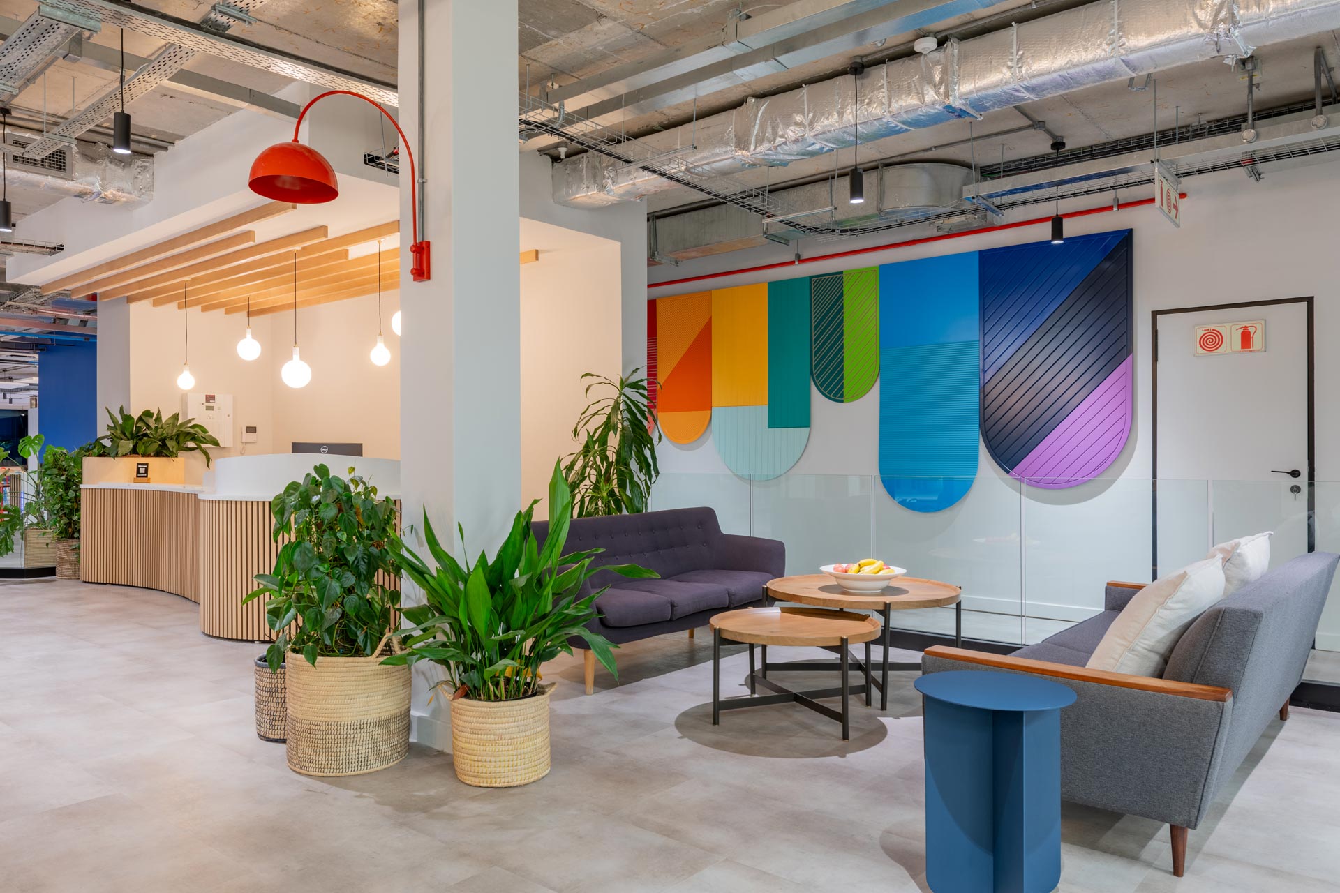 Waiting area with planters and colourful wall panels