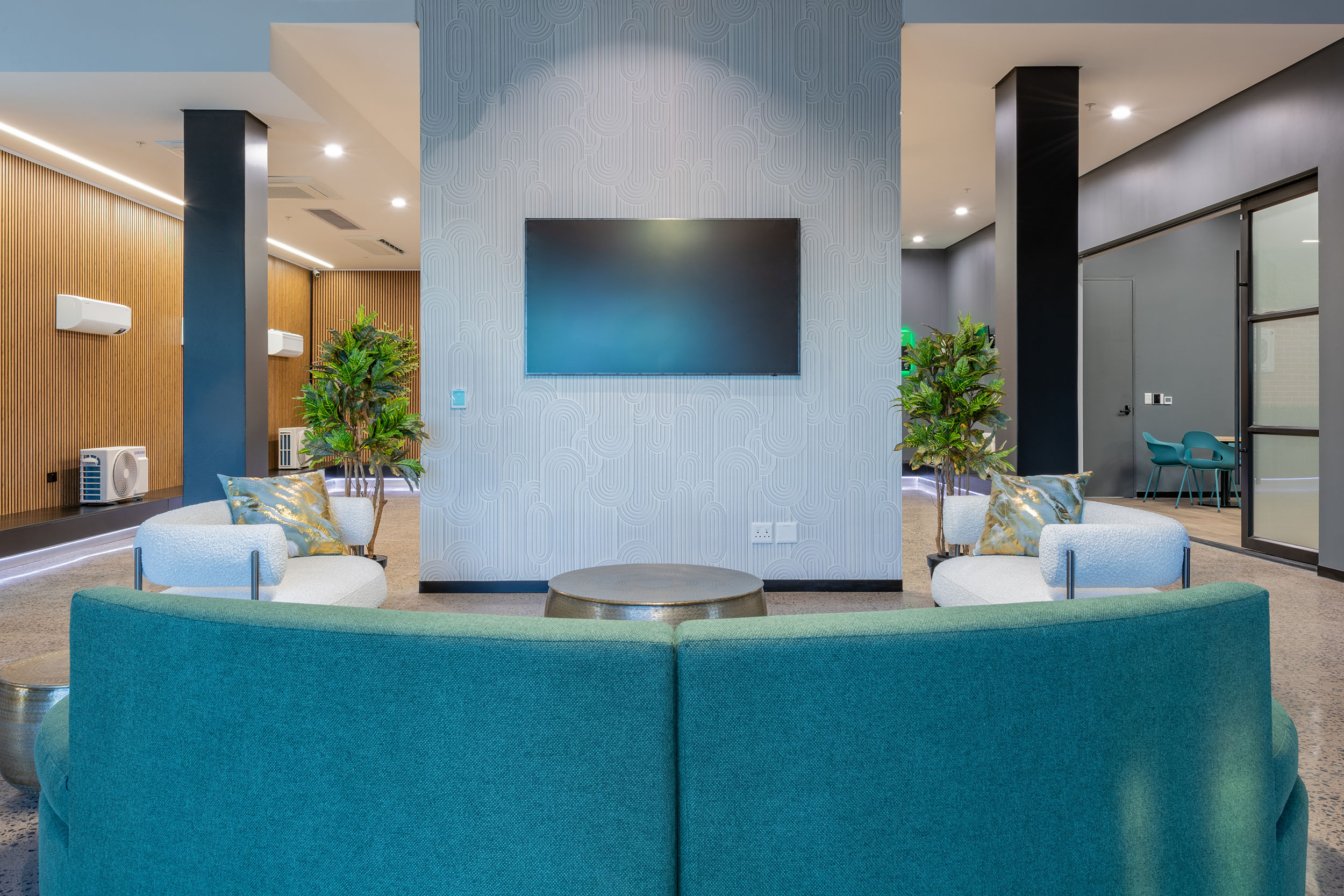Couch with tv in waiting room for new hvac offices in cape town