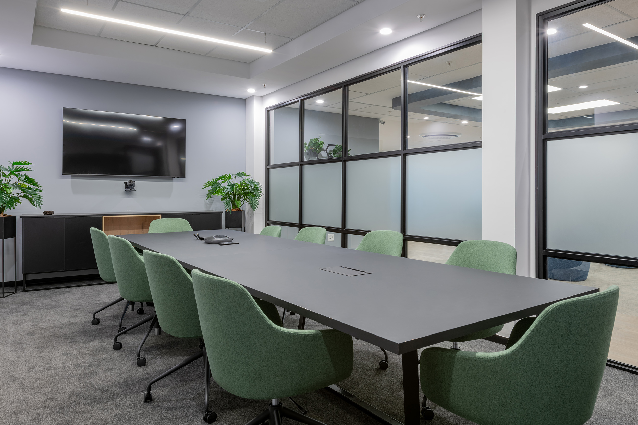 Boardroom with plush green chairs shows design and build skills