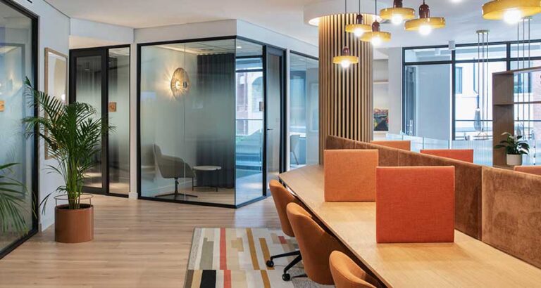 Workspace with acoustic partitions and focus rooms for different work flows