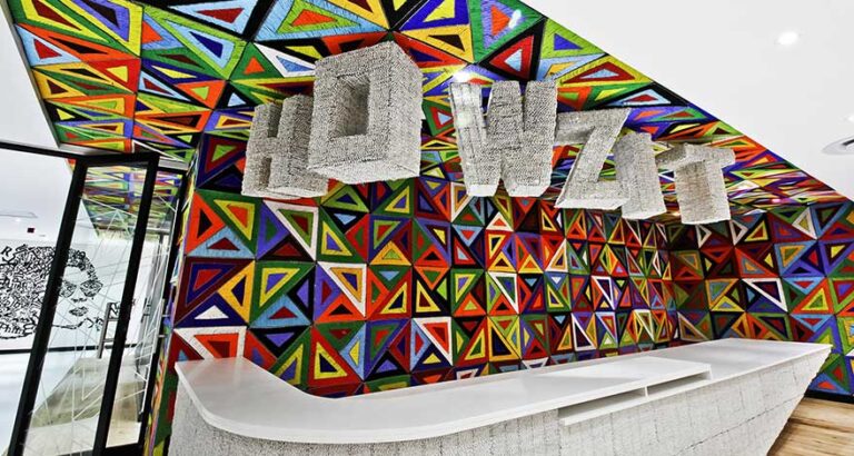 Creative Office reception desk for Google in South Africa with colourful brand-centric design