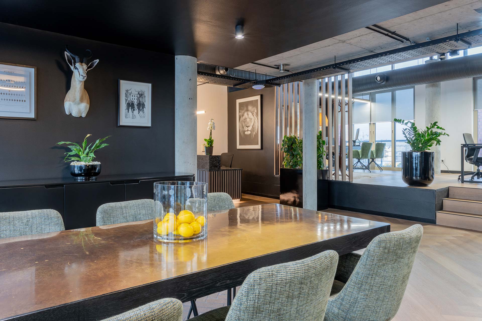 Lionhead Capital luxury office collaboration area with contemporary seating and earthy green tones in Cape Town