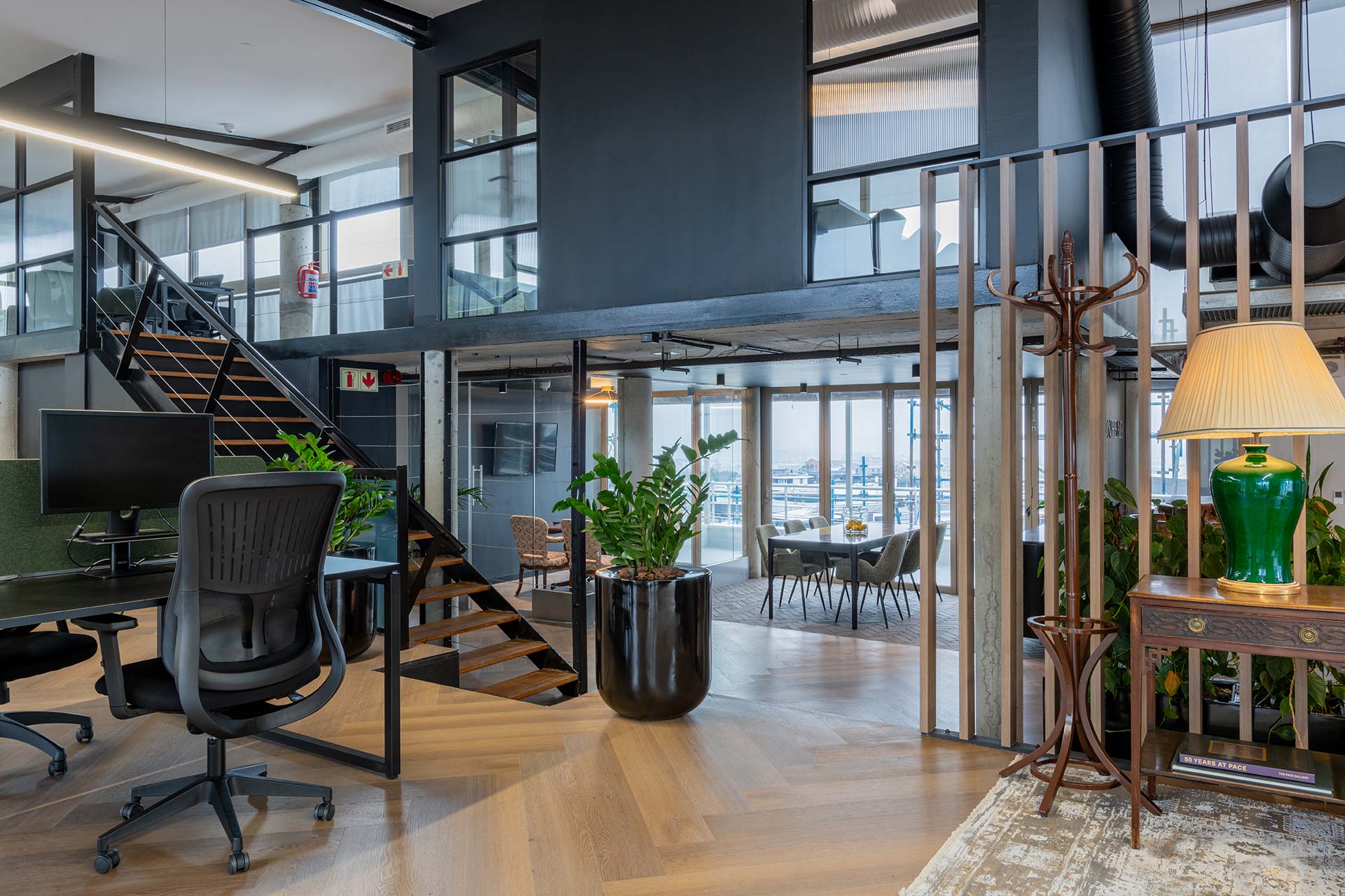 Lionhead Capital contemporary workplace design combining dark Scandinavian influences, glass partitions and ergonomic workstations