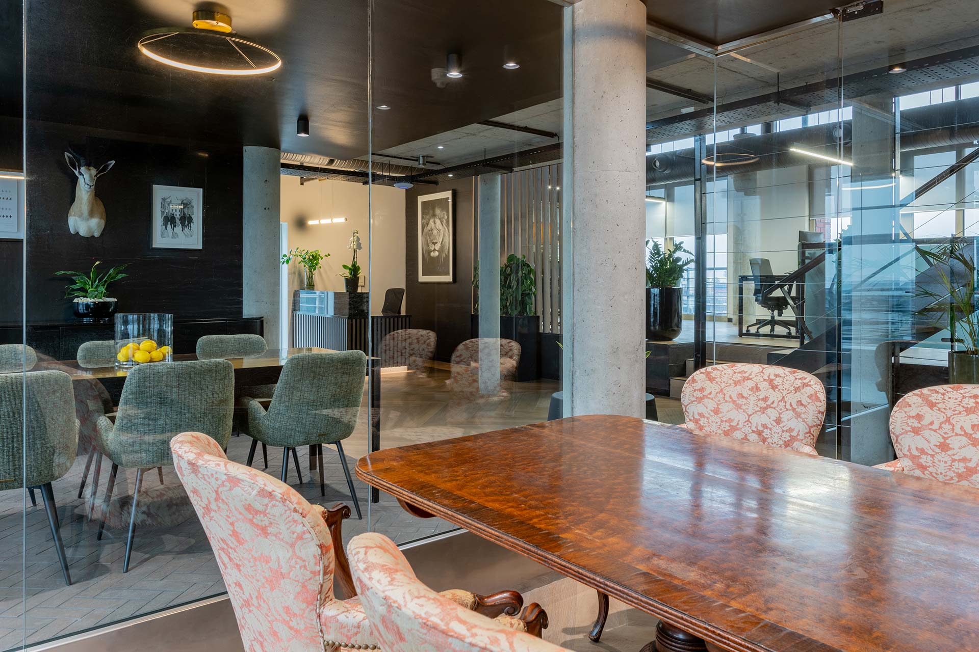 Lionhead Capital luxury meeting room with timber conference table, leather chairs and sophisticated dark interior finishes