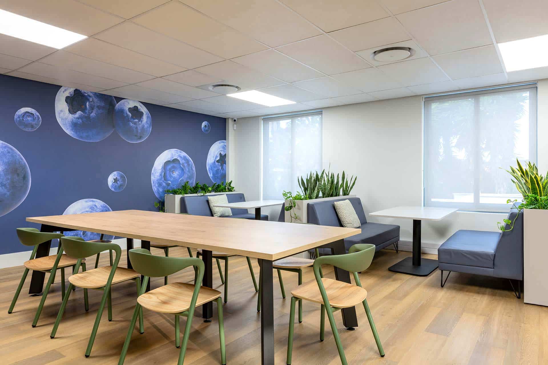 United Exports Paarl office canteen: interior design features wooden chairs, tables, and comfortable booth seating.